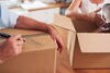 a person sitting in a box on a table